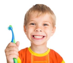 Smiling boy with tooth brush